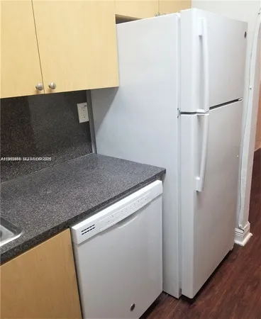 a white refrigerator freezer sitting inside of a kitchen