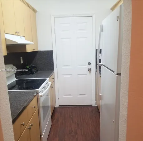 a kitchen with a sink and a refrigerator
