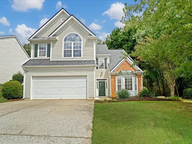 a front view of a house with a garden