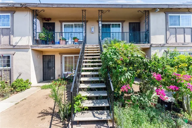 a view of a house with potted plants
