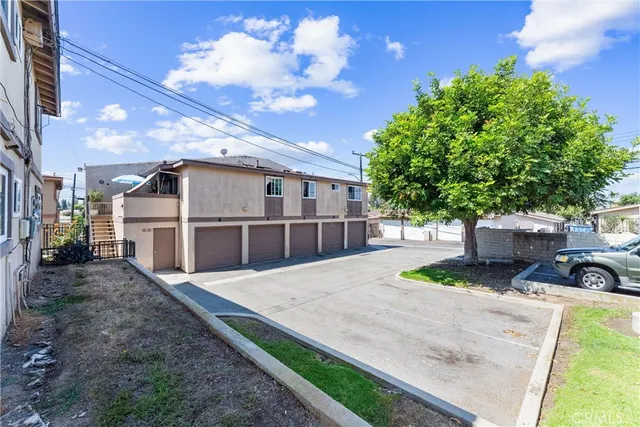 a view of a backyard with plants and a patio