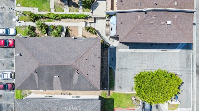 a aerial view of a house with a yard and potted plants