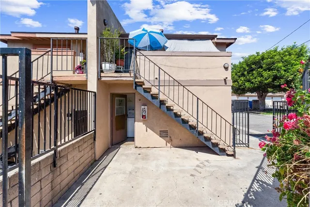 a view of staircase with railing and a chandelier