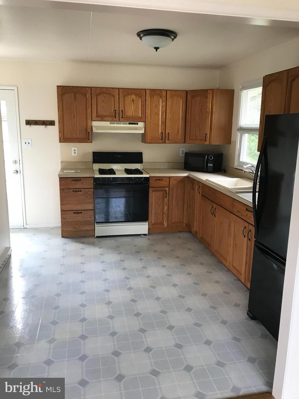 46 East Lemon Street Lititz, PA 17543 - Photo 4 of 8 a kitchen with granite countertop a refrigerator and a stove