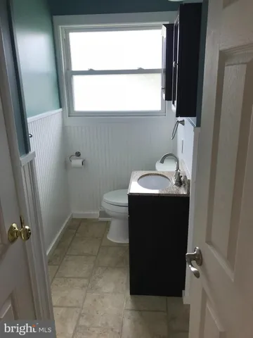 a view of green field with trees in the background