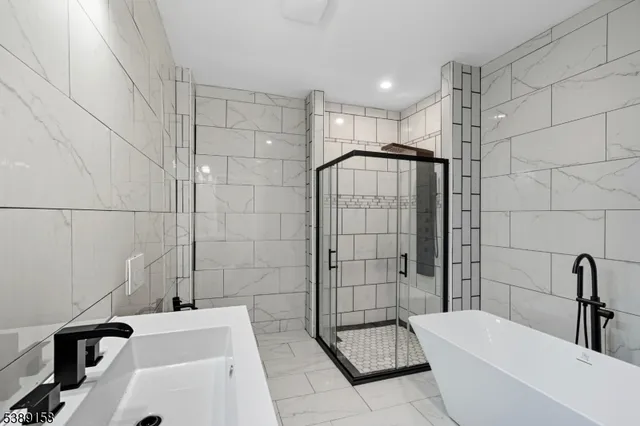 a bathroom with a bathtub and shower
