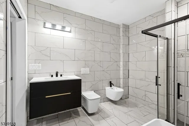 a bathroom with a toilet sink and shower