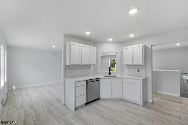 a kitchen with stainless steel appliances granite countertop a sink and cabinets