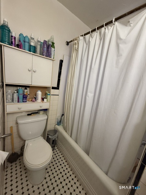 60 Capitol Avenue Meriden, CT 06451 - Photo 12 of 30 a bathroom with a toilet and a shower curtain