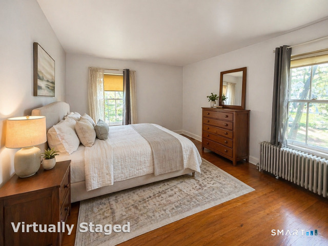 60 Capitol Avenue Meriden, CT 06451 - Photo 23 of 30 a bedroom with a bed and wooden floor