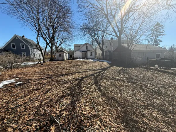 a backyard of a house with large trees