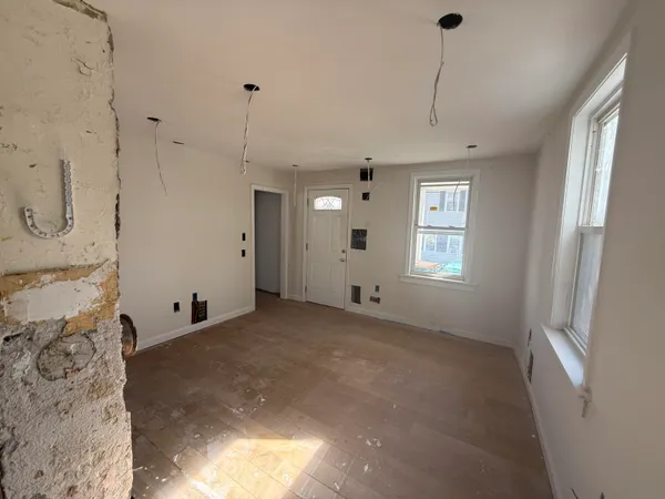 a view of a room with window and ceiling fan