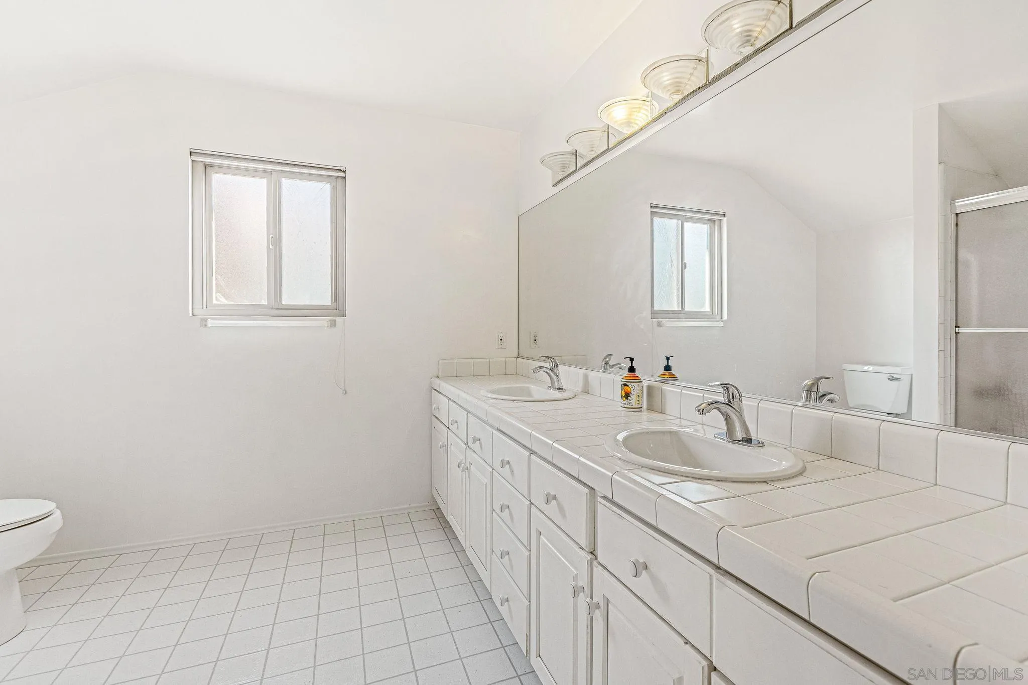 1983 David Drive Escondido, CA 92026 - Photo 21 of 55 a bathroom with a sink a toilet and a mirror