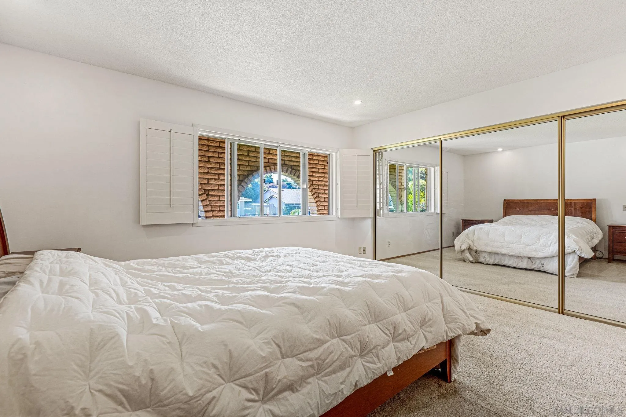 1983 David Drive Escondido, CA 92026 - Photo 31 of 55 a bedroom with a large bed and a large window