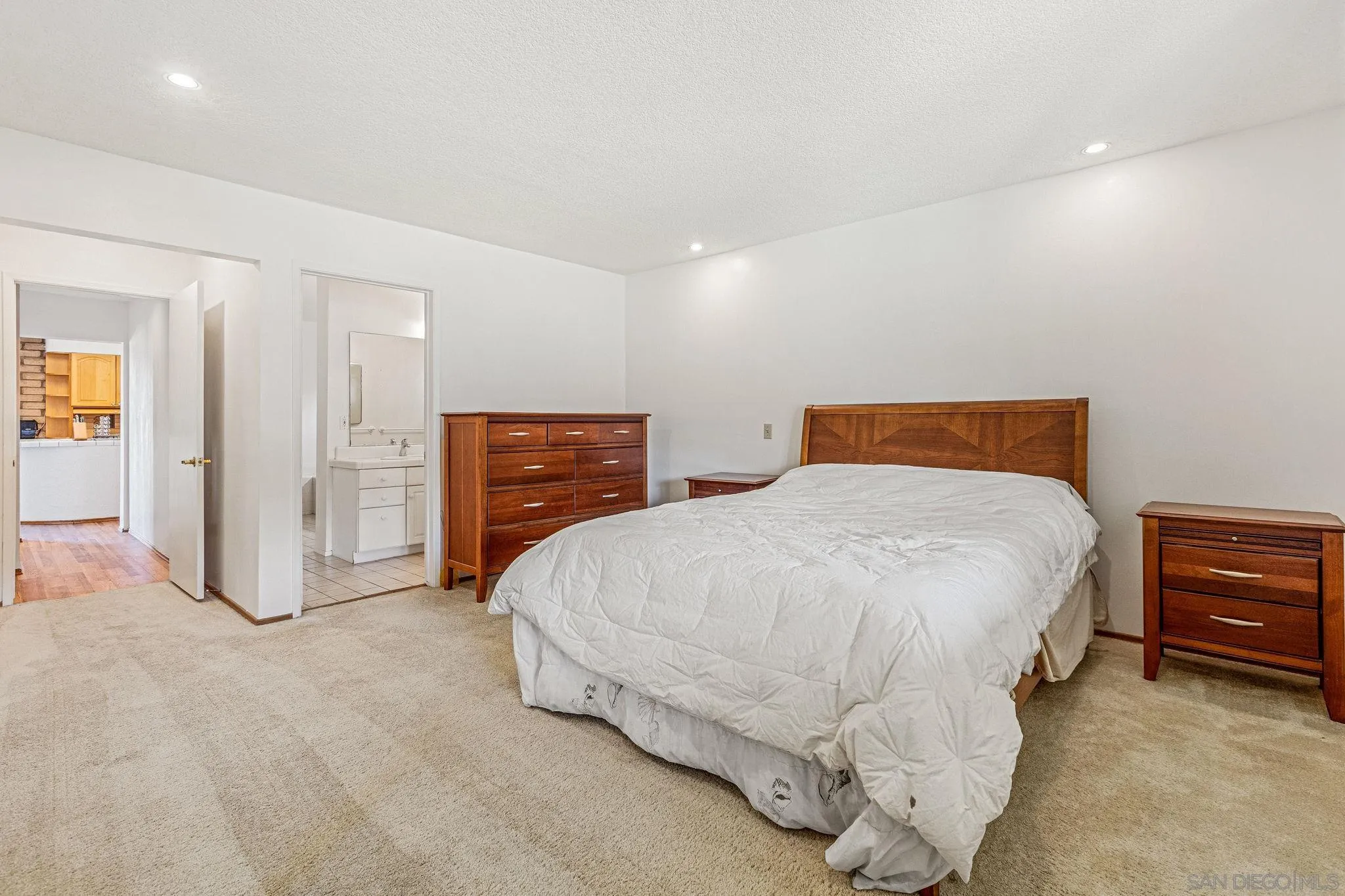 1983 David Drive Escondido, CA 92026 - Photo 32 of 55 a spacious bedroom with a bed and dresser