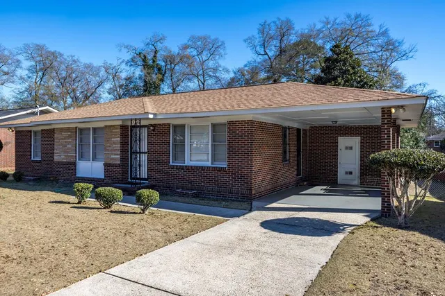 a front view of a house with garden and patio