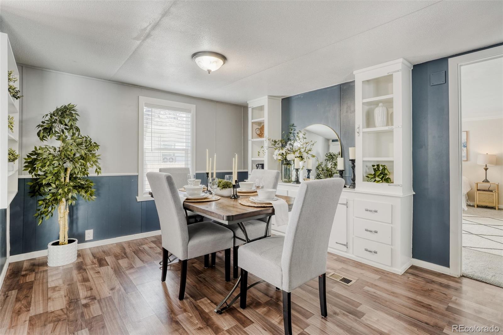 210 Pinto Street Golden, CO 80401 - Photo 14 of 35 a dining room with furniture potted plants and wooden floor