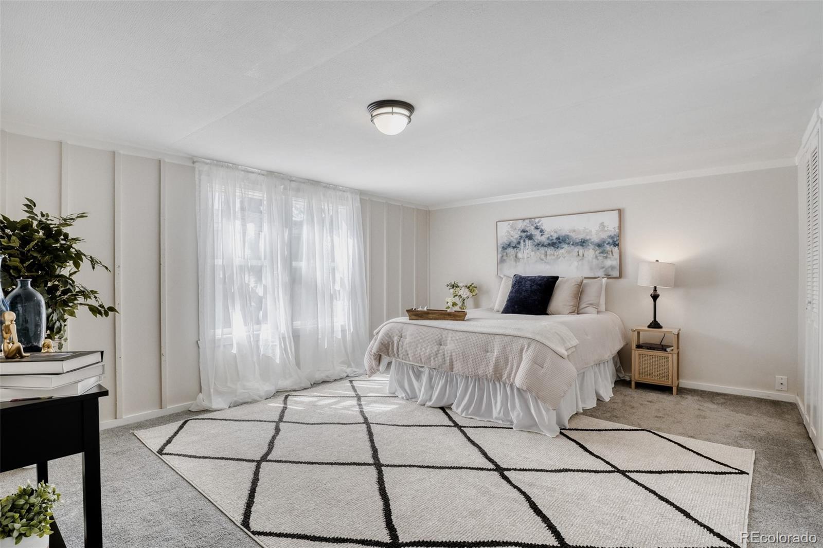 210 Pinto Street Golden, CO 80401 - Photo 16 of 35 a bed room with a bed and a potted plant