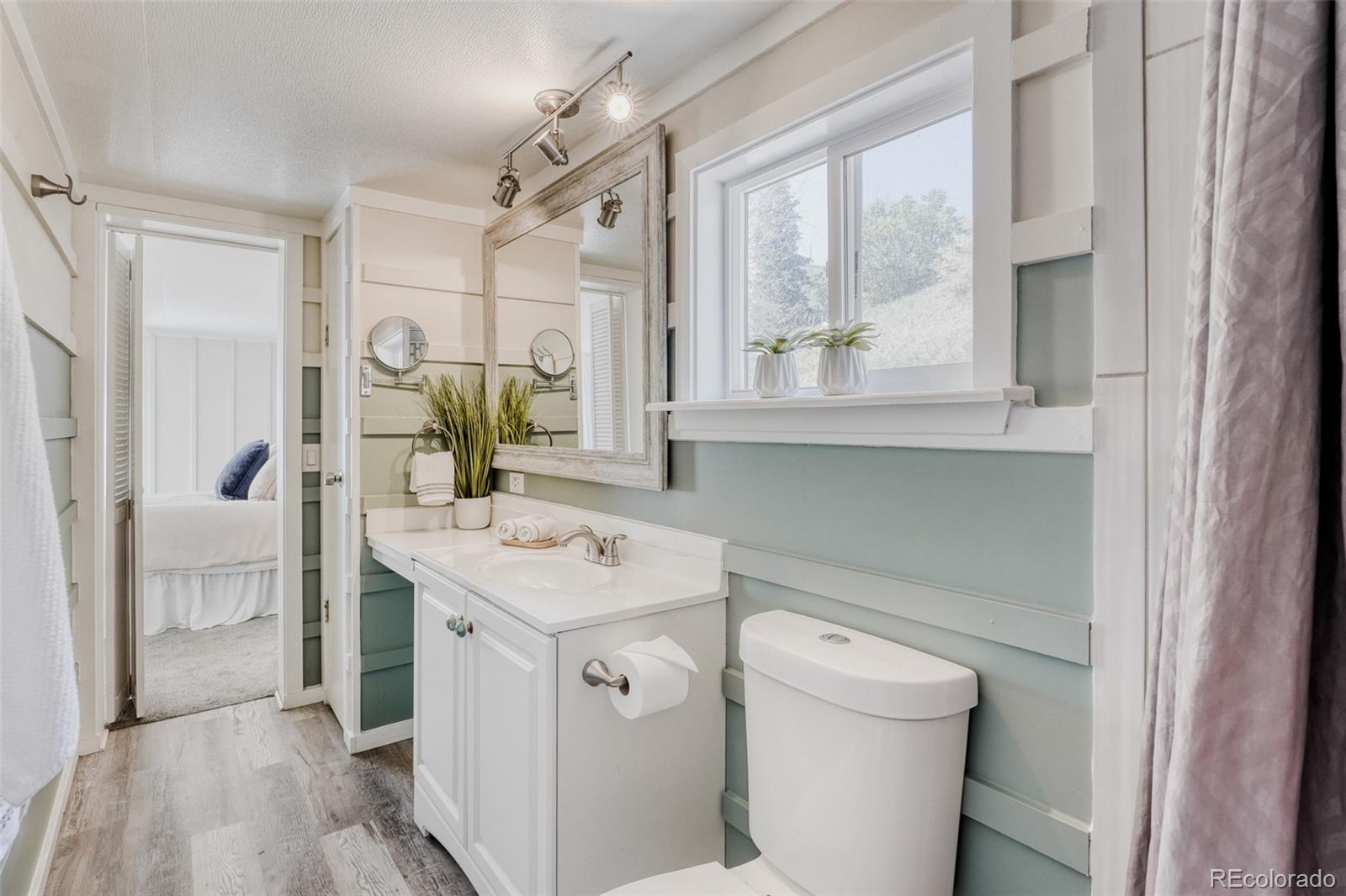 210 Pinto Street Golden, CO 80401 - Photo 19 of 35 a bathroom with a sink a toilet and a mirror