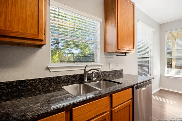 a kitchen with granite countertop a sink and a window