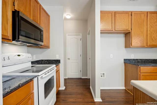 a kitchen with stainless steel appliances granite countertop a refrigerator and a microwave