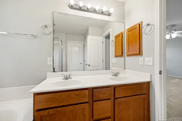 a bathroom with a sink vanity and a mirror
