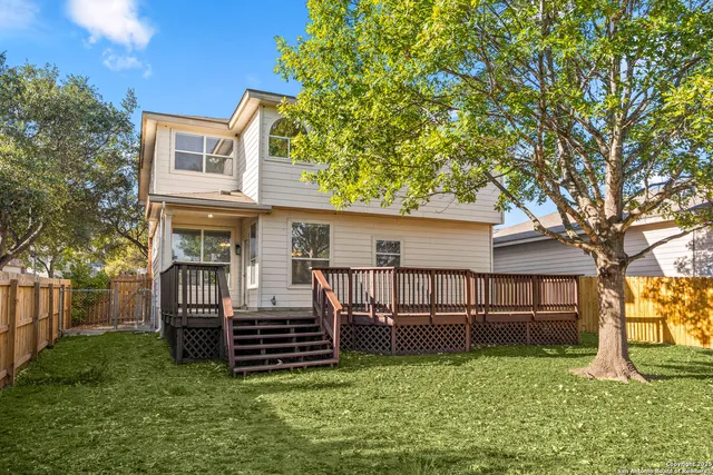 a view of backyard with a garden and deck