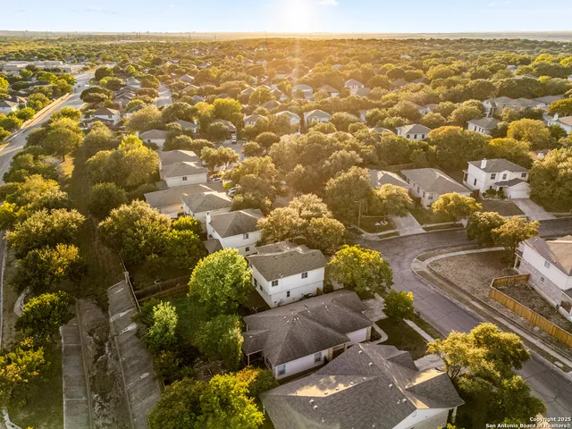 an aerial view of residential houses with outdoor space