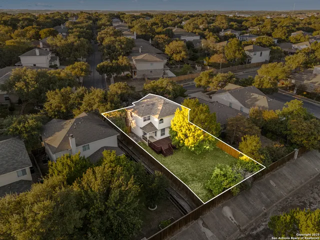 an aerial view of swimming pool with a yard