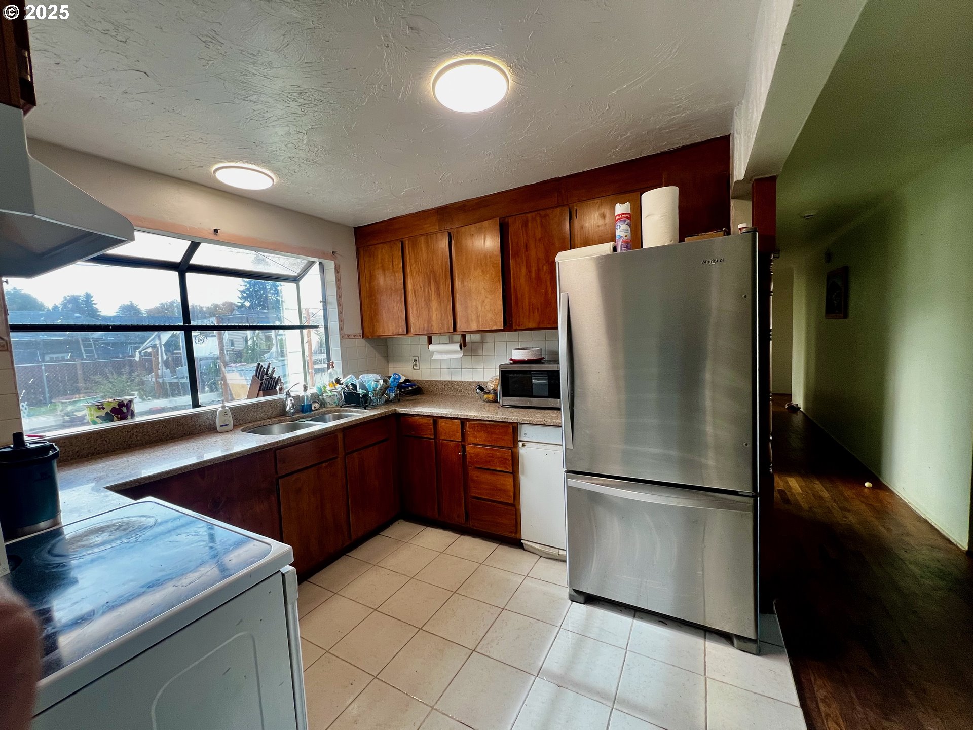 1271 Centennial Boulevard Springfield, OR 97477 - Photo 5 of 10 a kitchen with stainless steel appliances granite countertop a refrigerator a sink and a stove