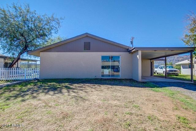 331 Hartford Road Kearny, AZ 85137 - Photo 40 of 40 a view of a house with a small yard and a large tree
