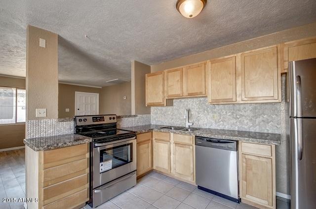 331 Hartford Road Kearny, AZ 85137 - Photo 5 of 40 a kitchen with granite countertop cabinets stainless steel appliances and a counter space