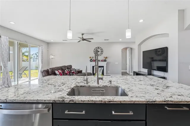 a bathroom with a tub a sink and a mirror