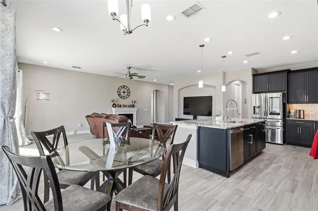a living room with furniture a table and a wooden floor
