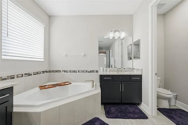 a view of walk in closet with wooden floor