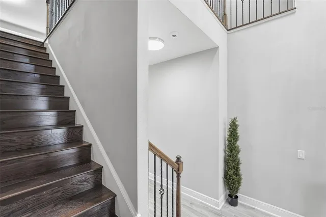 an aerial view of a house with a swimming pool and outdoor seating