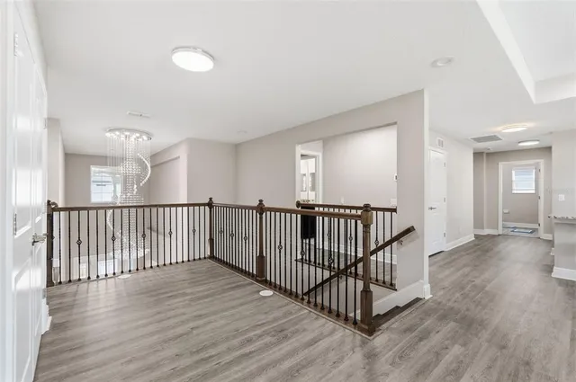 a view of a swimming pool with a yard and palm trees