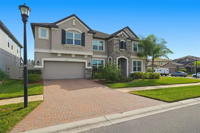 a front view of a house with a yard and garage