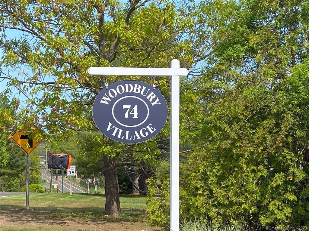 a sign that is next to a tree