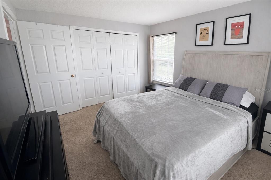 5483 Vineland Road, Unit 10301 Orlando, FL 32811 - Photo 12 of 13 a bedroom with a bed and a window