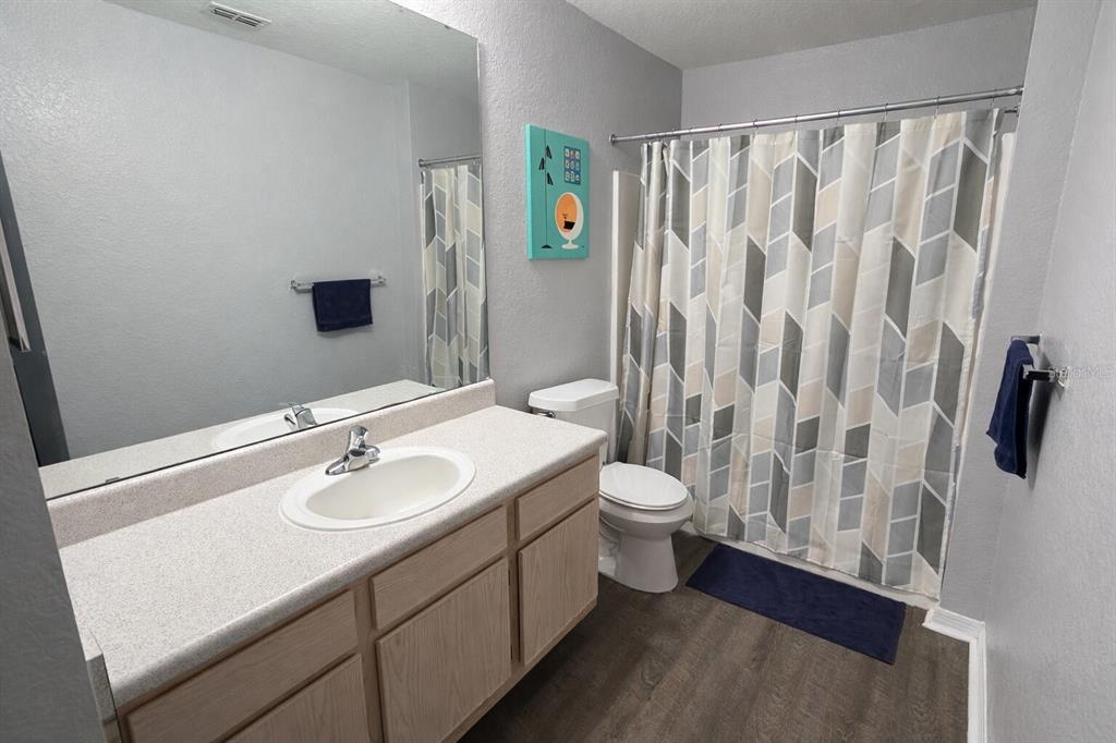 5483 Vineland Road, Unit 10301 Orlando, FL 32811 - Photo 13 of 13 a bathroom with a sink and a mirror