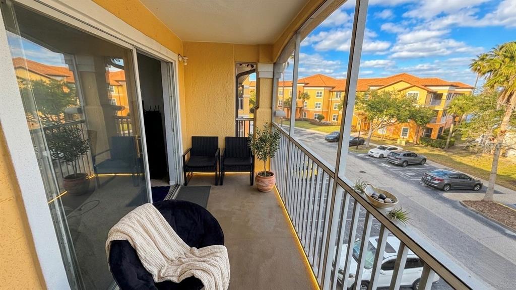 5483 Vineland Road, Unit 10301 Orlando, FL 32811 - Photo 2 of 13 a view of living room with balcony and furniture