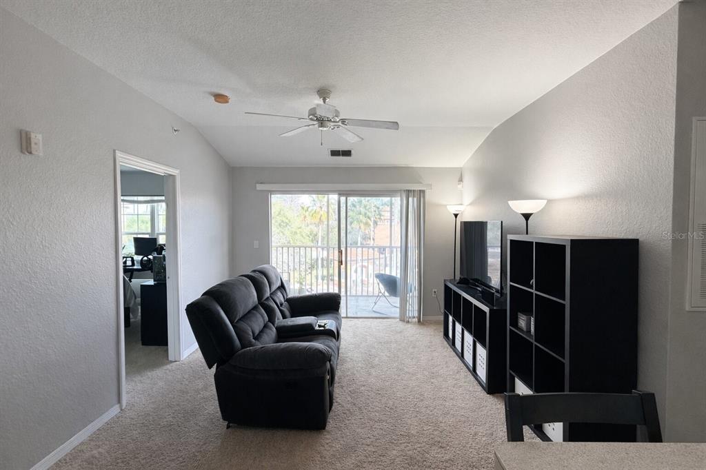 5483 Vineland Road, Unit 10301 Orlando, FL 32811 - Photo 4 of 13 a living room with furniture and a window