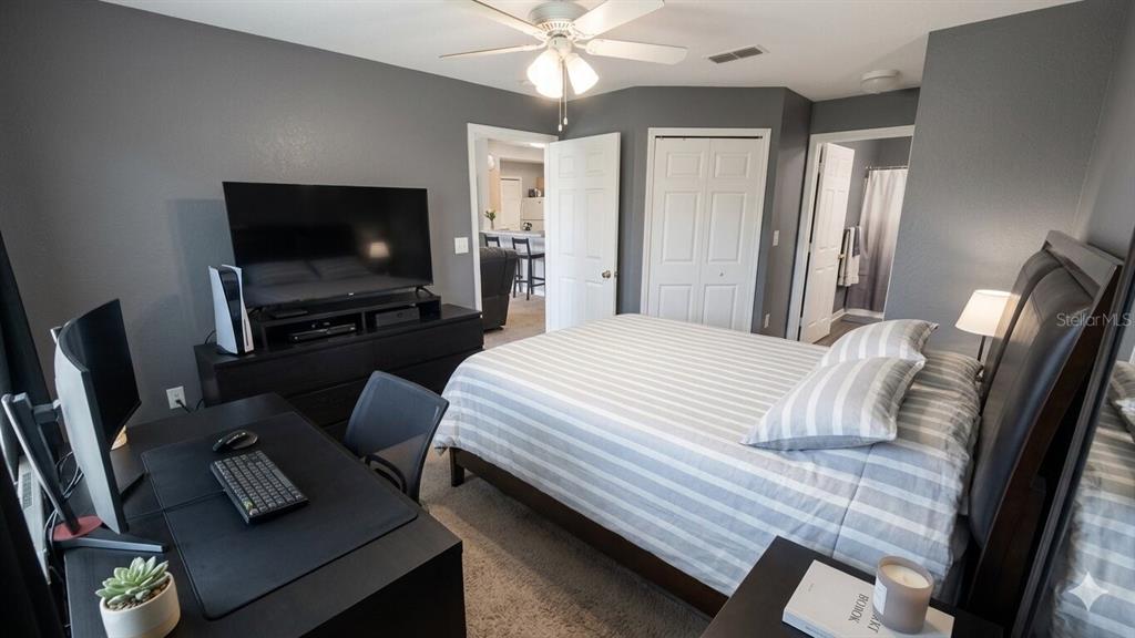 5483 Vineland Road, Unit 10301 Orlando, FL 32811 - Photo 8 of 13 a bedroom with a bed window and a flat screen tv