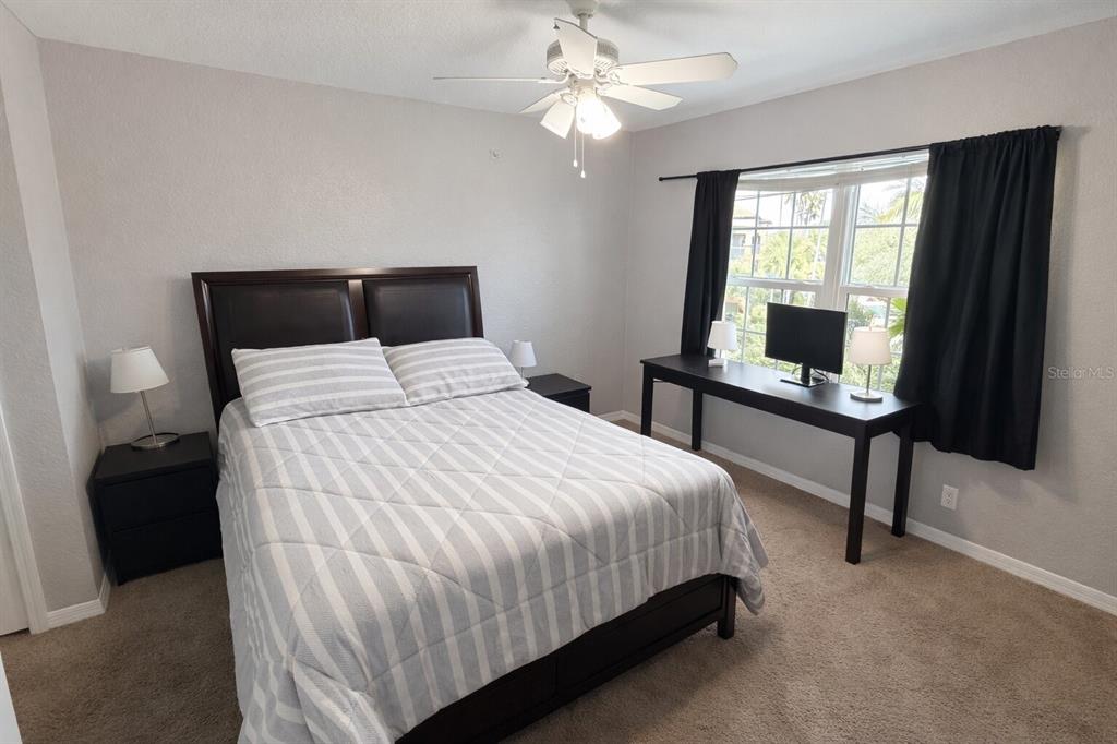 5483 Vineland Road, Unit 10301 Orlando, FL 32811 - Photo 9 of 13 a bedroom with a bed and a window