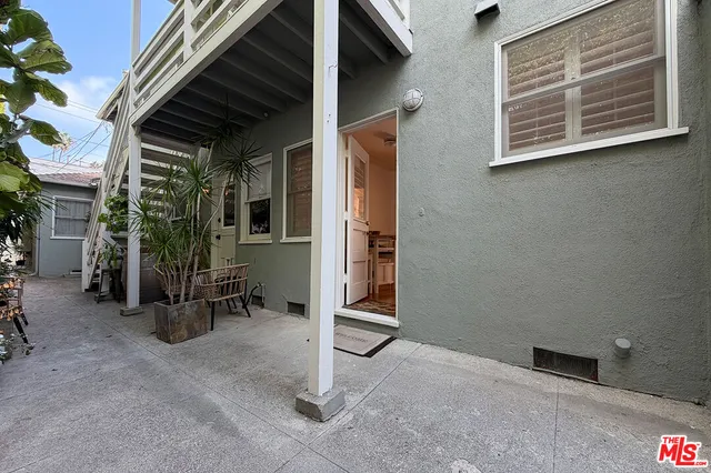 a view of a porch with barbeque grill and a table and chairs