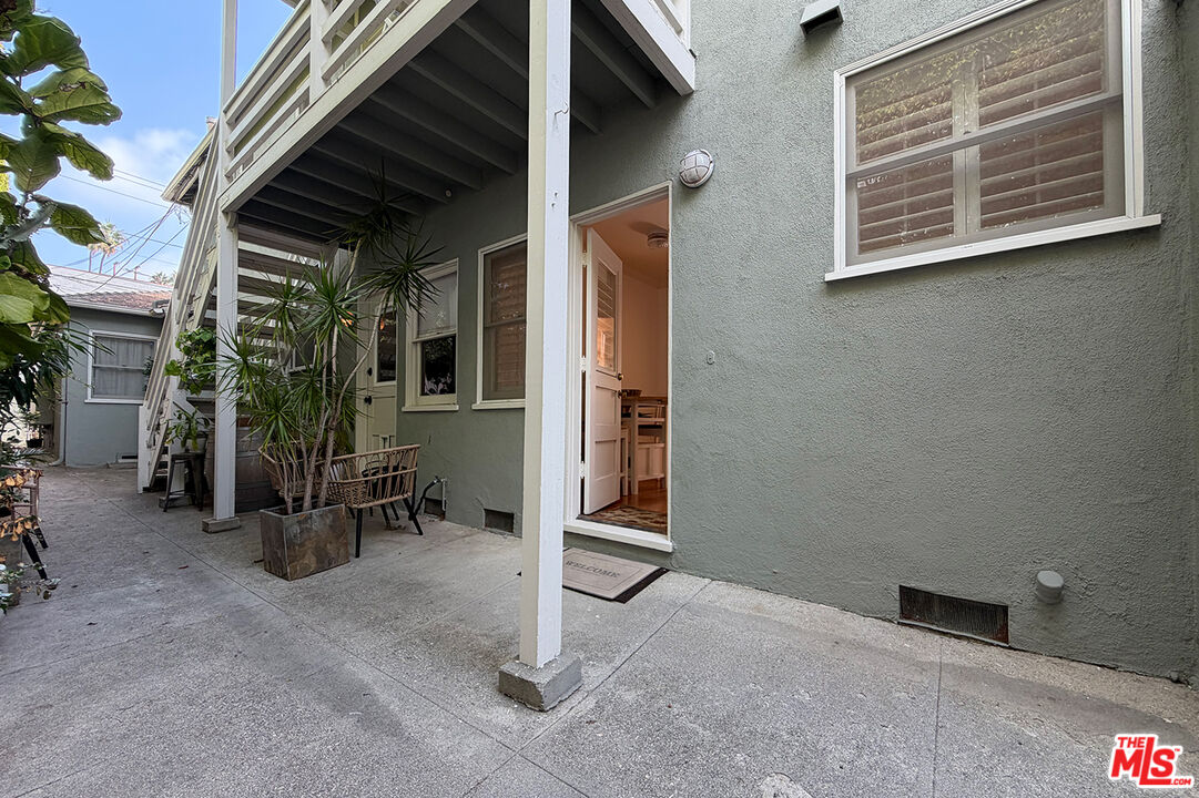 1701 Washington Avenue Santa Monica, CA 90403 - Photo 12 of 15 a view of a porch with barbeque grill and a table and chairs