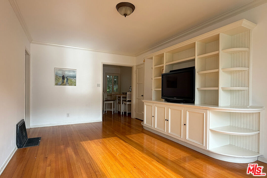 1701 Washington Avenue Santa Monica, CA 90403 - Photo 3 of 15 a living room with a flat screen tv and a wooden floor