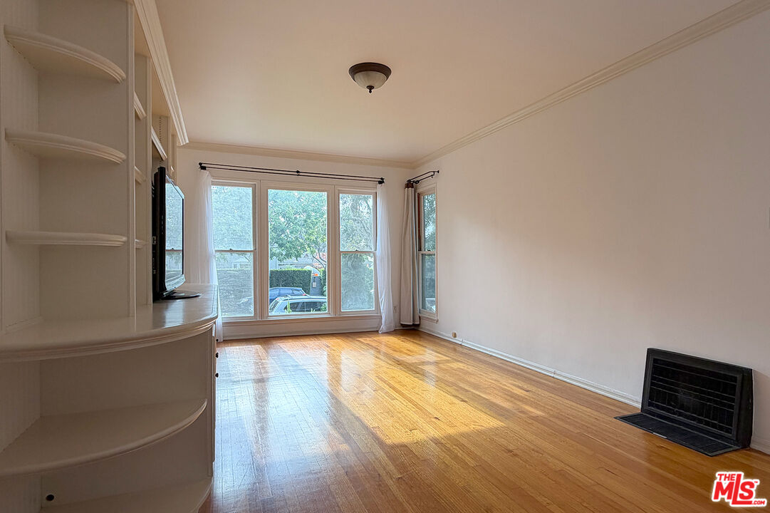 1701 Washington Avenue Santa Monica, CA 90403 - Photo 4 of 15 a view of an empty room with wooden floor and a window