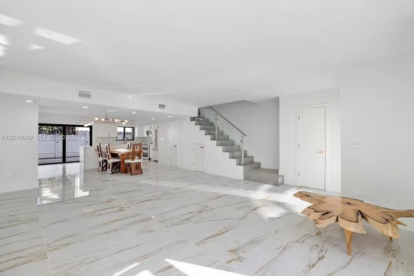 a view of a livingroom with dining room and wooden floor